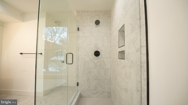 bathroom with a shower with shower door