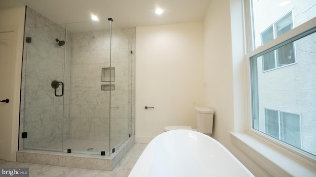 bathroom featuring separate shower and tub, plenty of natural light, and toilet