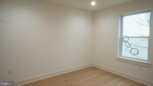 spare room featuring plenty of natural light and light hardwood / wood-style flooring