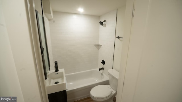 bathroom featuring tiled shower / bath and toilet