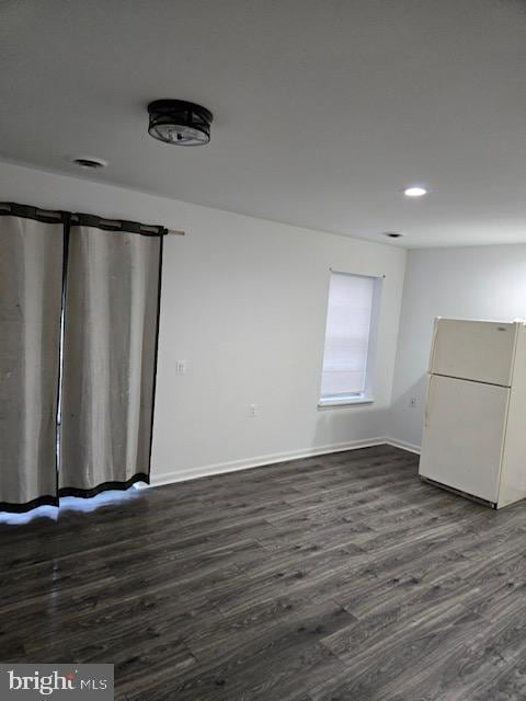 empty room with dark wood-type flooring