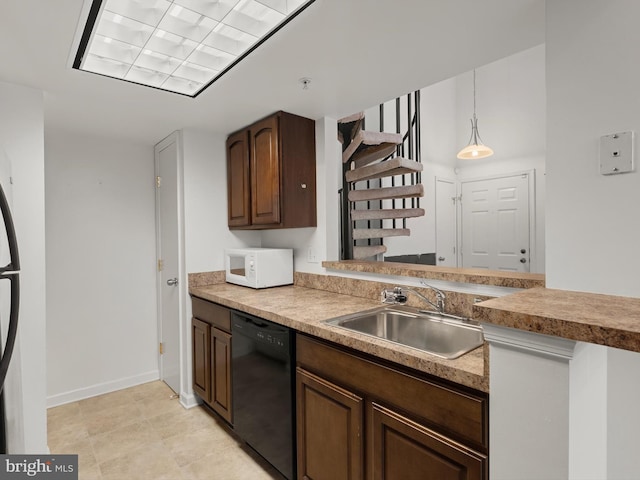 kitchen featuring dishwasher, pendant lighting, and sink