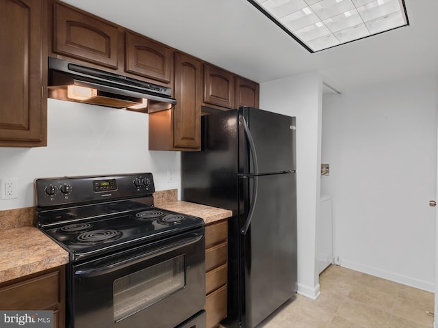 kitchen featuring dark brown cabinetry and black appliances