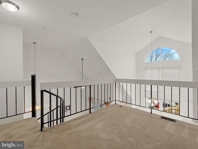 interior space with carpet, a chandelier, and vaulted ceiling