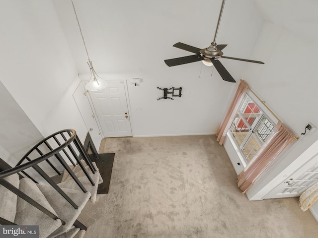 interior space featuring ceiling fan and carpet floors