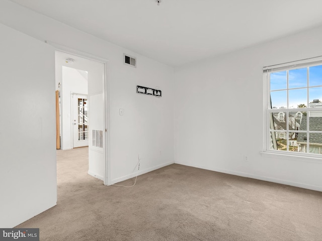 unfurnished room with light carpet