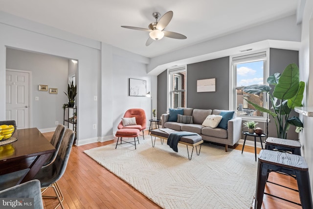 living room with ceiling fan and light hardwood / wood-style flooring