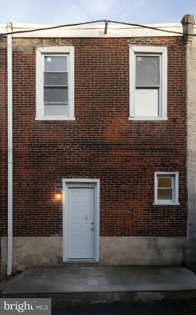 exterior space featuring brick siding