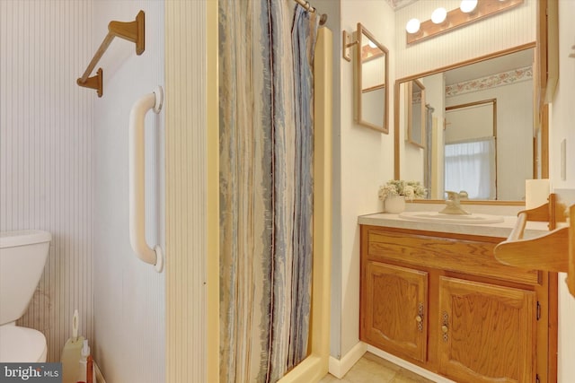 bathroom featuring a shower with curtain, tile patterned flooring, vanity, and toilet