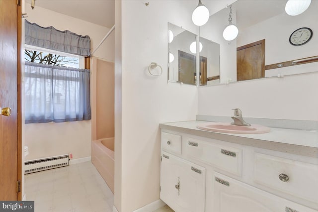 bathroom featuring vanity, bathing tub / shower combination, and a baseboard heating unit