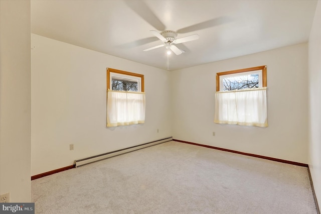 empty room with light carpet, ceiling fan, and a baseboard heating unit