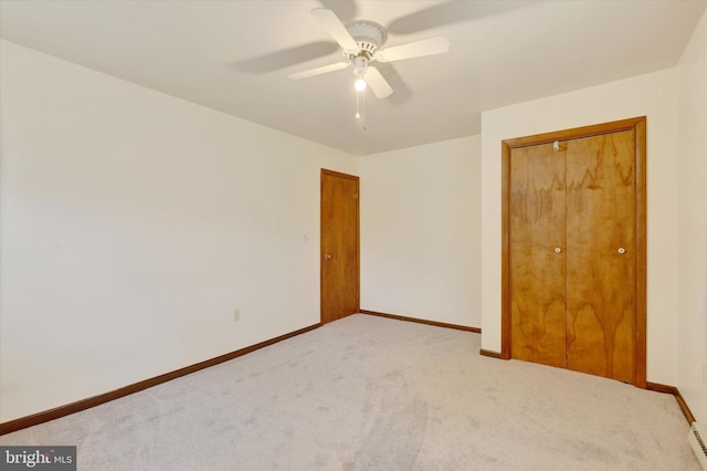 unfurnished bedroom featuring ceiling fan, light colored carpet, and a closet