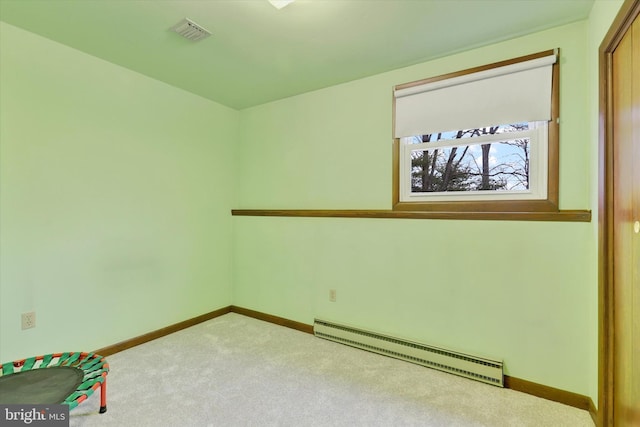 carpeted spare room featuring a baseboard radiator