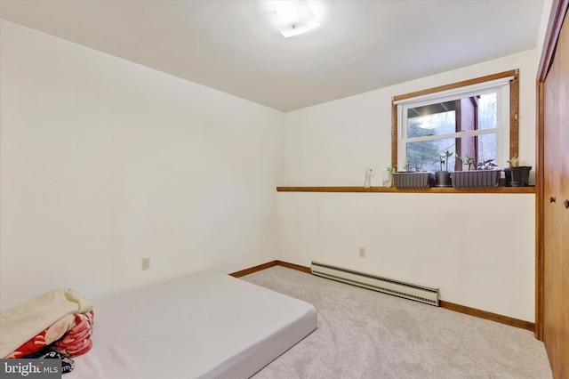 bedroom featuring light colored carpet and baseboard heating