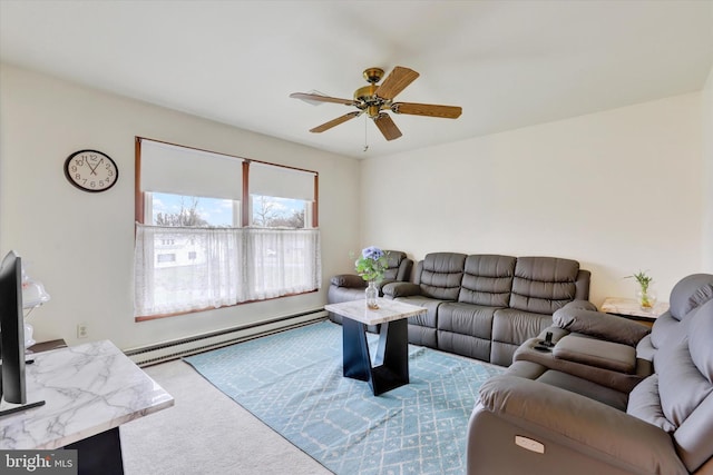 living room with ceiling fan, carpet floors, and a baseboard heating unit