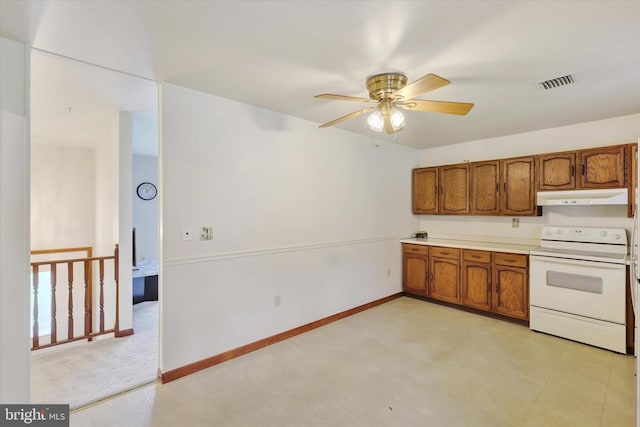 kitchen with ceiling fan, electric stove, and light carpet