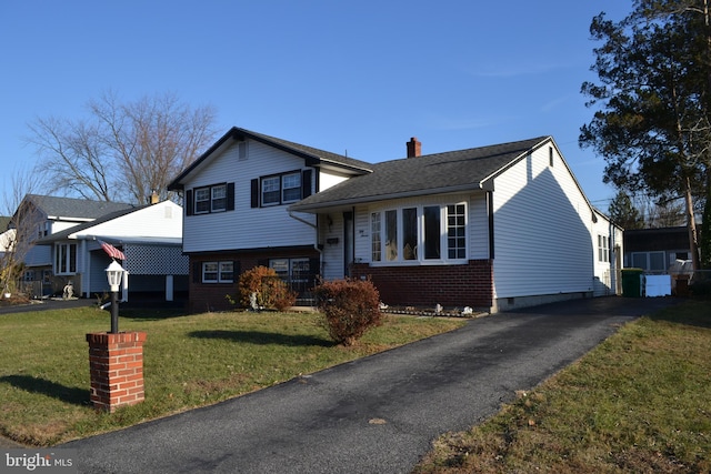 tri-level home with a front lawn