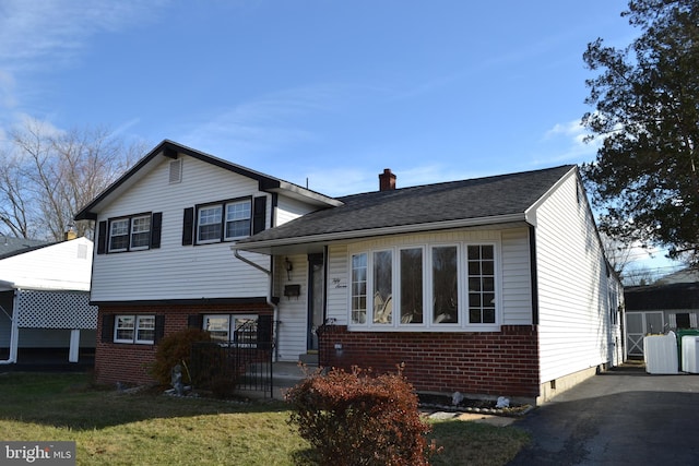 split level home with a porch and a front lawn