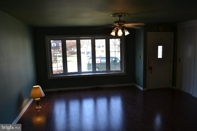 foyer entrance featuring ceiling fan and dark wood-type flooring