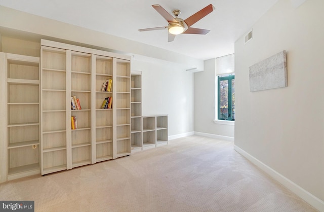 carpeted empty room featuring ceiling fan