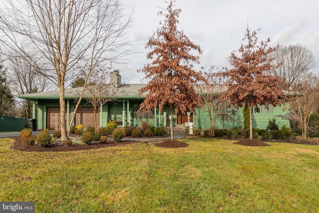 view of front of property with a garage and a front yard