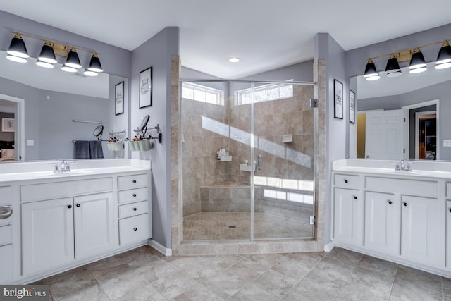 bathroom with vanity and a shower with shower door