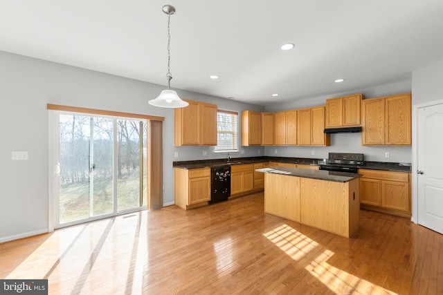 kitchen with a center island, hanging light fixtures, a healthy amount of sunlight, and black appliances