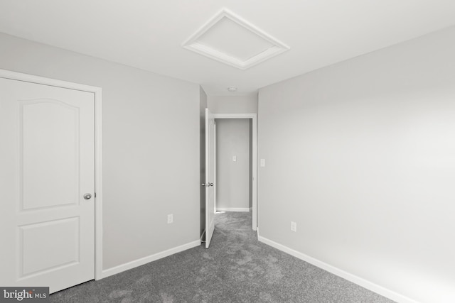 unfurnished bedroom featuring dark carpet