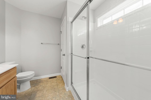 bathroom with vanity, toilet, and an enclosed shower