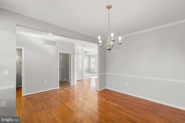 unfurnished dining area with ceiling fan with notable chandelier, wood-type flooring, and vaulted ceiling