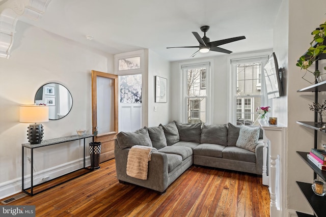 living room with wood-type flooring and ceiling fan