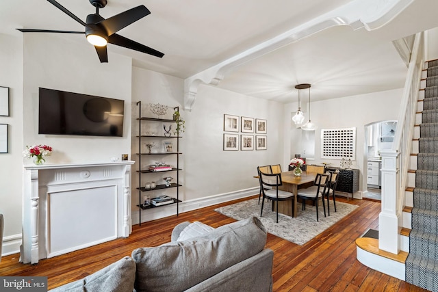 dining area with dark wood-type flooring and ceiling fan