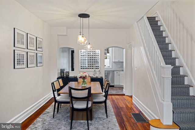 dining space with hardwood / wood-style flooring