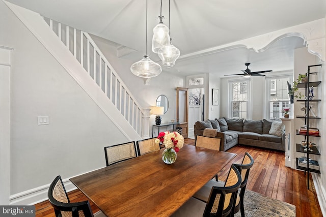 dining area with dark wood-type flooring and ceiling fan