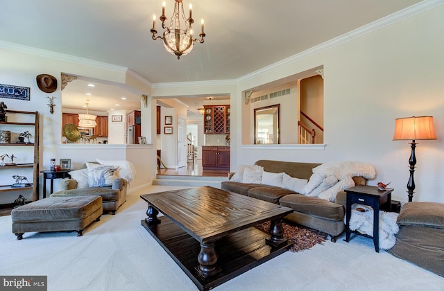 living room with carpet flooring, crown molding, and a chandelier