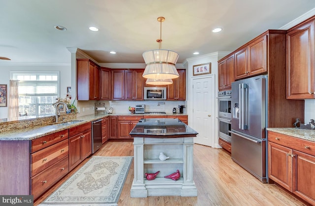 kitchen with backsplash, light hardwood / wood-style flooring, a kitchen island, and stainless steel appliances