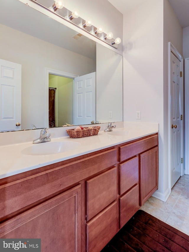 bathroom with tile patterned flooring and vanity