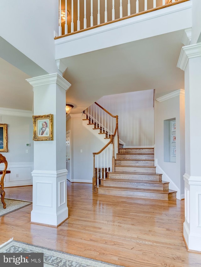 staircase featuring hardwood / wood-style floors and crown molding