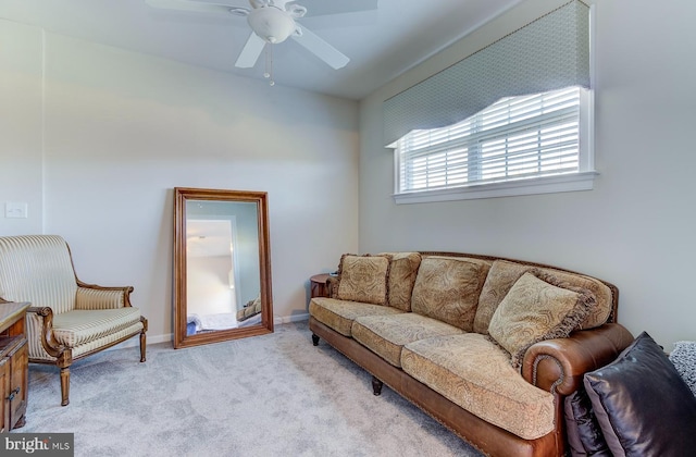 living room with ceiling fan and light colored carpet