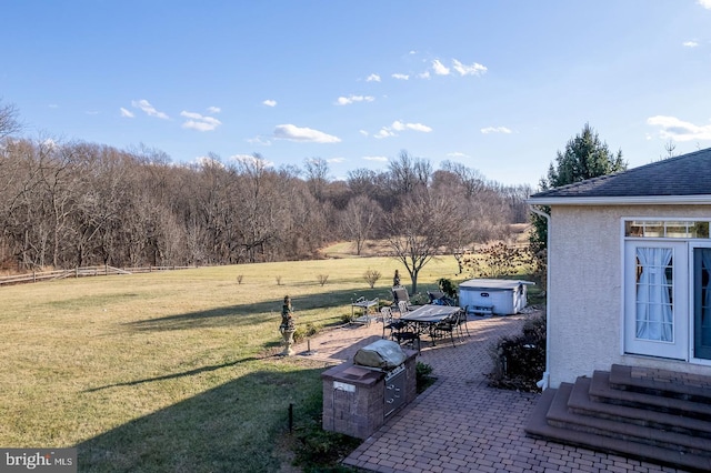 view of yard featuring a patio area, a rural view, and a hot tub