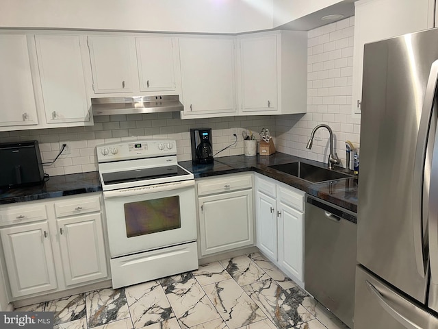 kitchen featuring white cabinetry, sink, appliances with stainless steel finishes, and tasteful backsplash