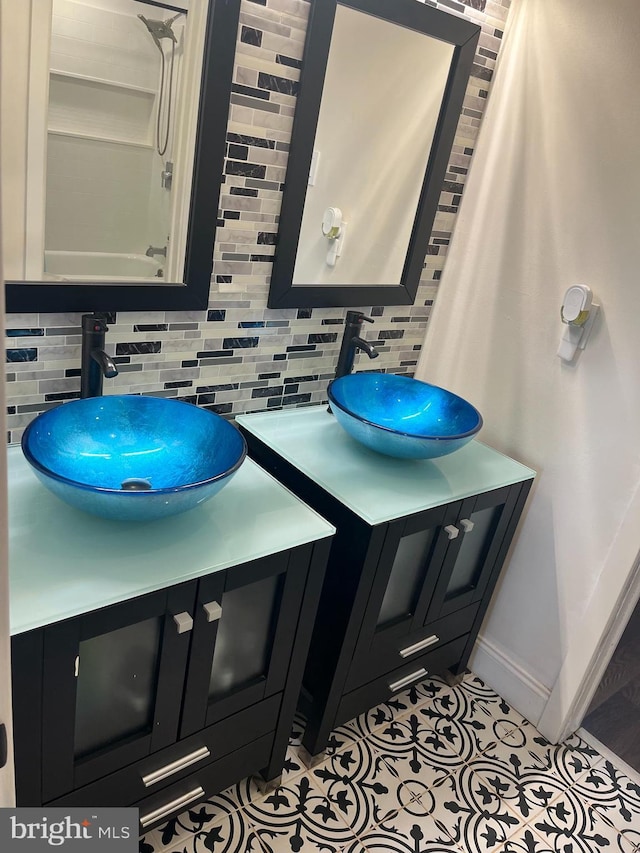 bathroom featuring vanity, backsplash, and tile patterned floors