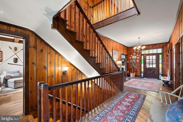 3007 Faulkland Rd, Wilmington, DE 19808 - foyer with wood walls, hardwood / wood-style flooring, a chandelier, and stairs