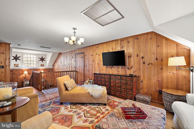 3007 Faulkland Rd, Wilmington, DE 19808 - living room with wooden walls, wood finished floors, and a chandelier