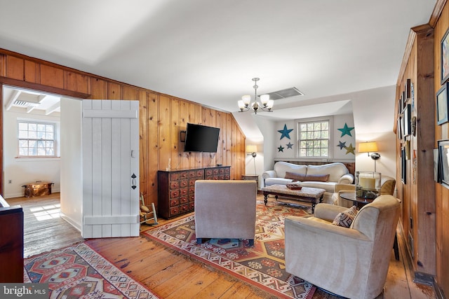 3007 Faulkland Rd, Wilmington, DE 19808 - living area featuring a chandelier, hardwood / wood-style floors, and wooden walls