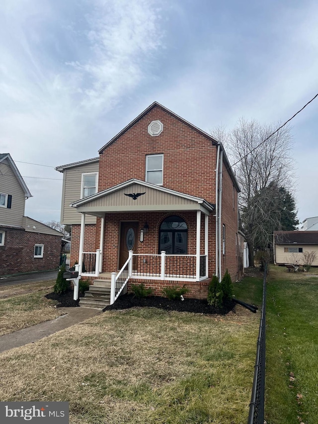 view of front of house featuring a front lawn and covered porch