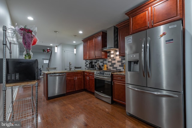 kitchen featuring kitchen peninsula, tasteful backsplash, wall chimney exhaust hood, stainless steel appliances, and sink