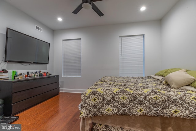 bedroom with dark hardwood / wood-style floors and ceiling fan