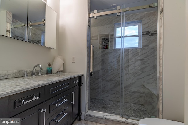 bathroom with vanity, toilet, and walk in shower