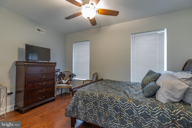 bedroom with ceiling fan and wood-type flooring